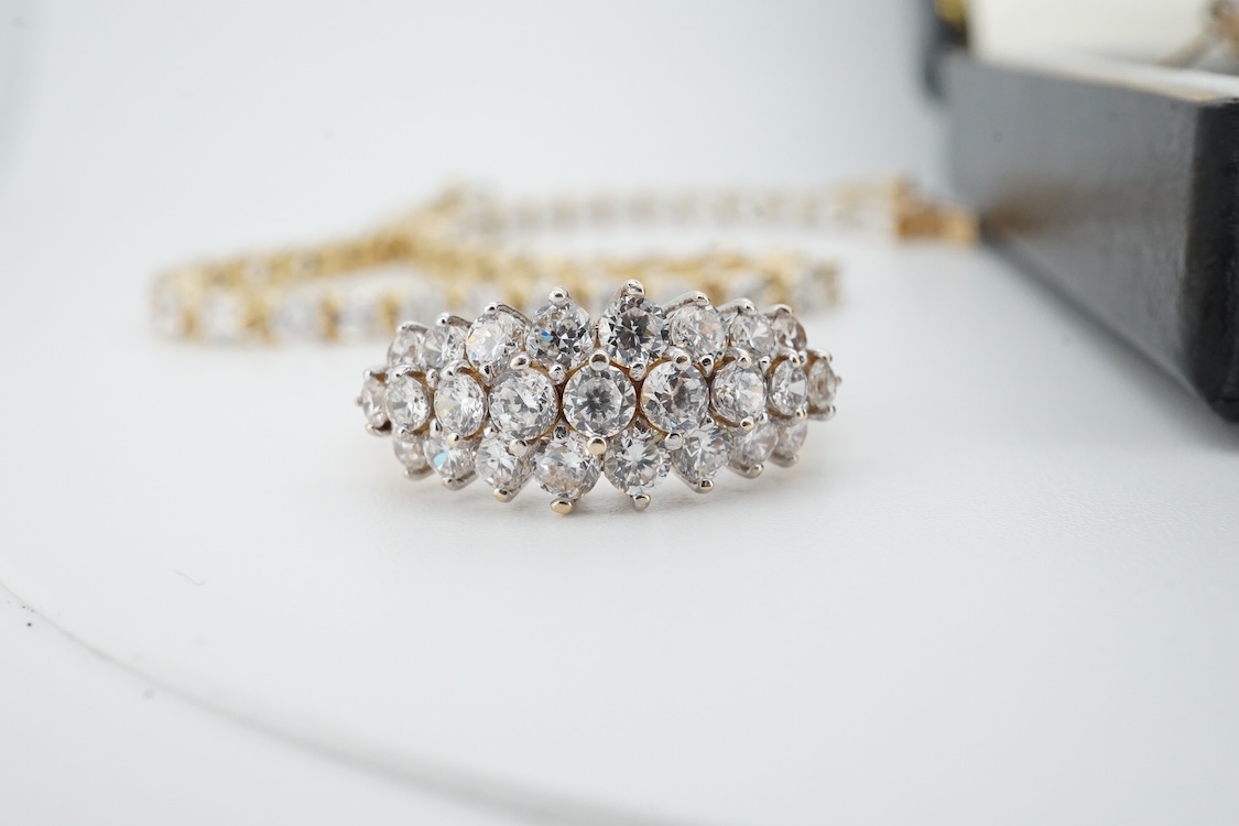 A modern yellow metal (stamped 585) and cubic zirconia set line bracelet, 18cm and a pair of similar drop earrings, together with a similar 9k and cubic zirconia set cluster ring, size N.